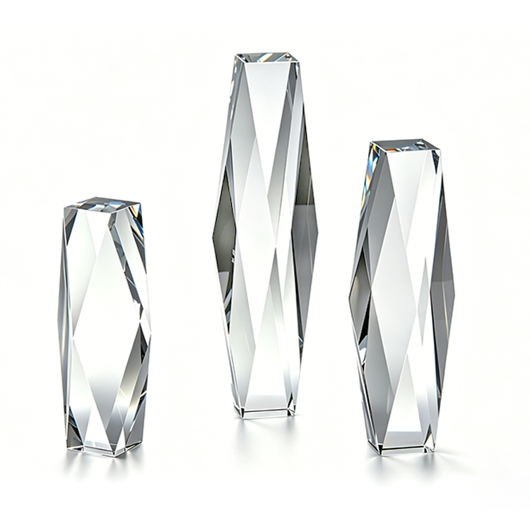 Three faceted K9 crystal tower awards in graduated heights, polished optical crystal with sharp reflective edges